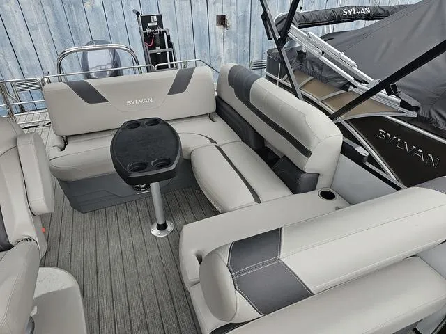 Slide: The Image of 2022 Sylvan L-3 CLZ pontoon boat interior with gray seating and table. - 11