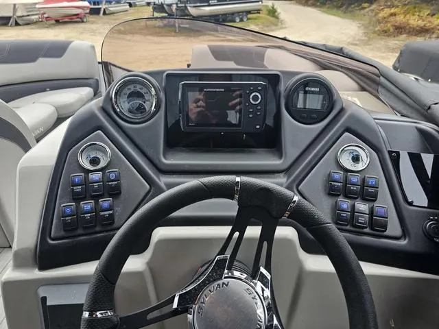Slide: The Image of 2022 Sylvan L-3 CLZ boat dashboard with steering wheel and control panel. - 13