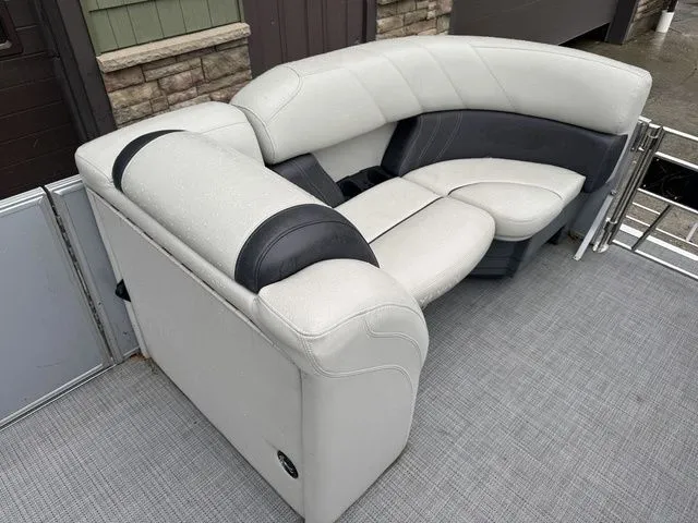 Slide: The Image of 2022 Sylvan 8522 LZ boat interior with gray and black cushioned seating. - 13