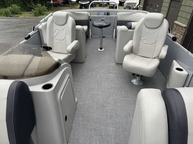 Slide: The Image of 2022 Sylvan 8522 LZ pontoon boat interior with plush seating and table. - 14