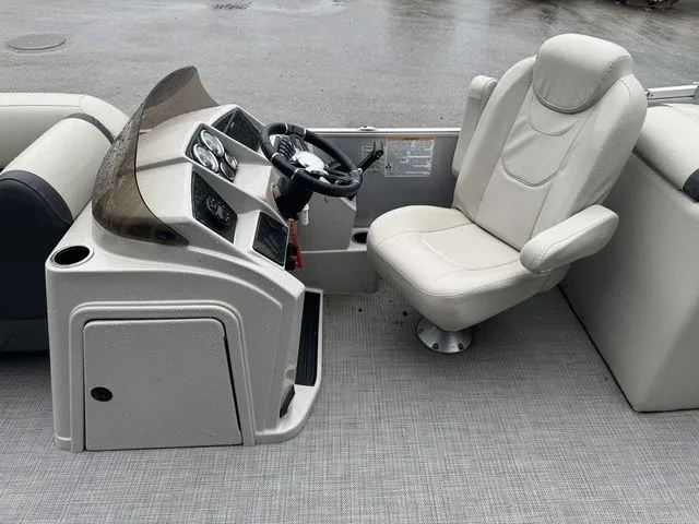 Slide: The Image of 2022 Sylvan 8522 LZ boat interior with steering console and captain's chair. - 15