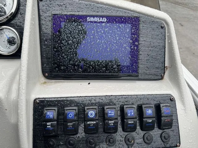 Slide: The Image of Control panel of a 2022 Sylvan 8522 LZ boat with Simrad display and switches. - 18