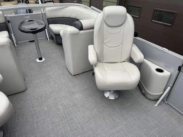 Slide: The Image of 2022 Sylvan 8522 LZ pontoon boat interior with plush seating and table. - 20