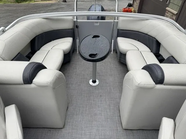 Slide: The Image of 2022 Sylvan 8522 LZ pontoon boat interior with gray seating and central table. - 21