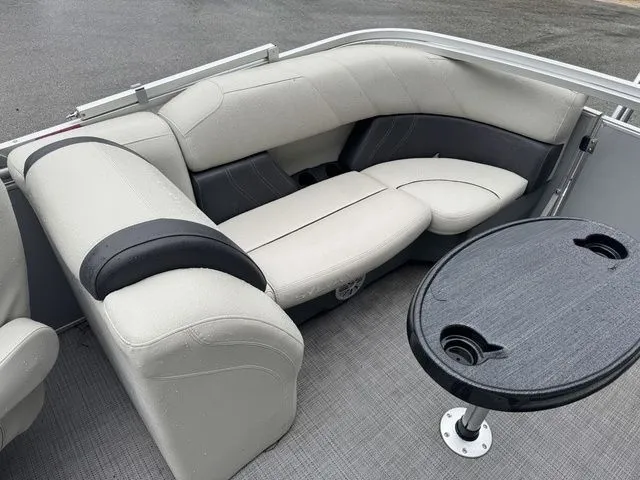 Slide: The Image of 2022 Sylvan 8522 LZ boat interior with gray seating and a round table. - 22