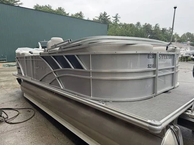 Slide: The Image of 2022 Sylvan 8522 LZ pontoon boat in a marina setting. - 9