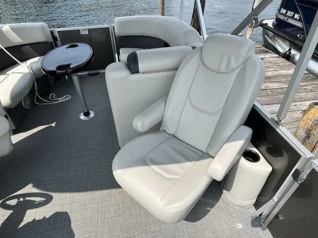 Slide: The Image of Luxurious seating on 2022 Sylvan 8520 LZ pontoon boat with gray upholstery and table. - 10