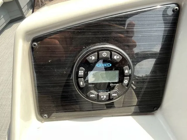 Slide: The Image of Jensen audio system on 2022 Sylvan 8520 LZ boat dashboard. - 14