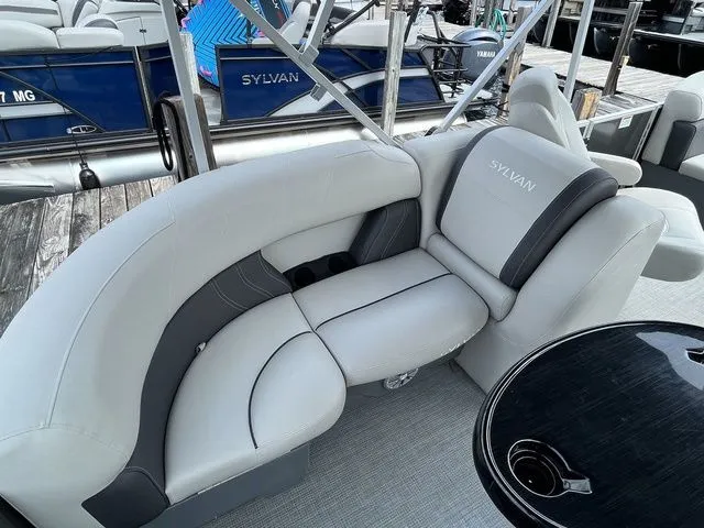 Slide: The Image of 2022 Sylvan 8520 LZ pontoon boat with luxurious gray seating and cup holders. - 18
