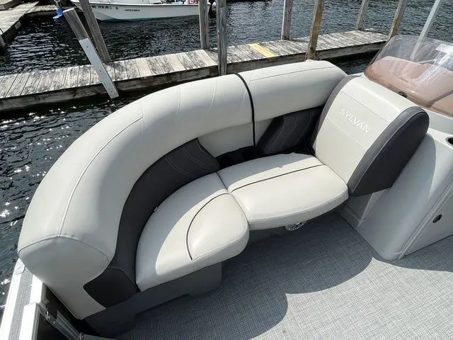Slide: The Image of 2022 Sylvan 8520 LZ boat with stylish gray seating at a dock. - 8