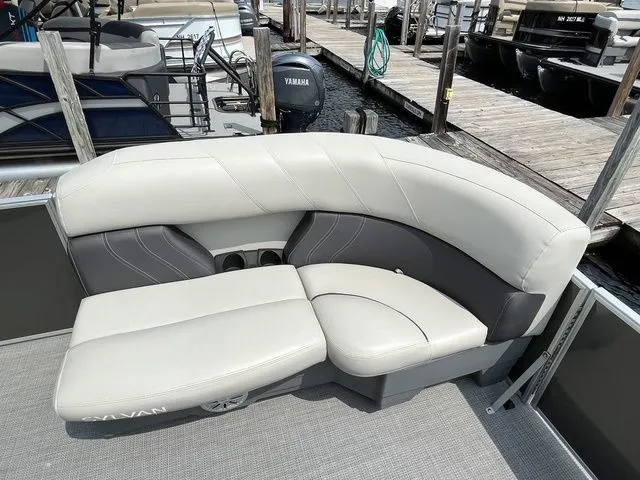 Slide: The Image of 2022 Sylvan 8520 LZ pontoon boat with beige and gray seating at a dock. - 9