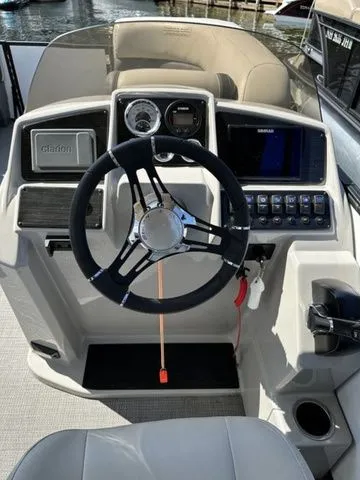 Slide: The Image of 2022 Sylvan X1 boat dashboard with steering wheel and control panel. - 8