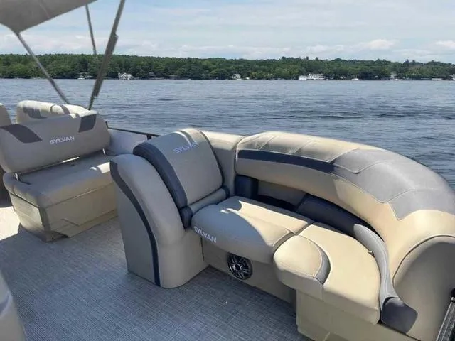 Slide: The Image of 2022 Sylvan L-3 CLZ pontoon boat with luxurious seating on a serene lake. - 3