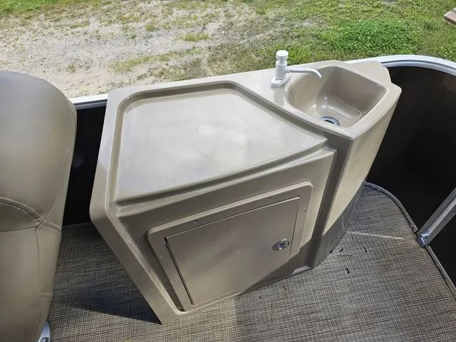 Slide: The Image of 2023 Sylvan 8522 CRS SG boat sink and counter with storage on deck. - 7