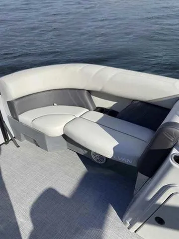 Slide: The Image of 2023 Sylvan X1 boat interior with gray seating on calm water. - 10