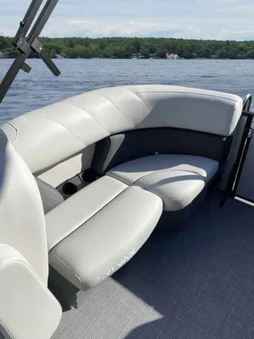 Slide: The Image of 2023 Sylvan X1 boat interior with gray seating on a calm lake. - 12