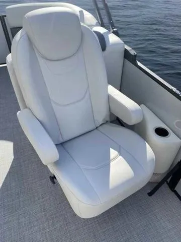 Slide: The Image of Luxurious white seat on 2023 Sylvan X1 boat, featuring armrests and cup holder. - 7