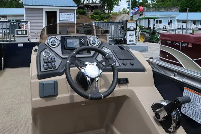 Slide: The Image of 2023 Sylvan L-3 DLZ BAR boat dashboard with steering wheel and controls. - 10