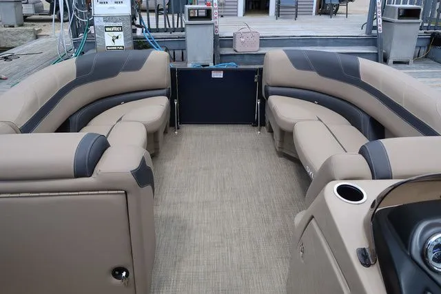 Slide: The Image of 2023 Sylvan L-3 DLZ BAR pontoon boat interior with beige seating and modern design. - 11