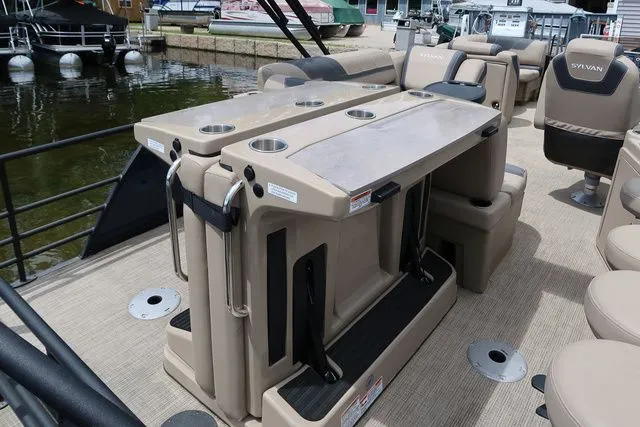 Slide: The Image of 2023 Sylvan L-3 DLZ BAR pontoon boat interior with bar seating and cup holders. - 18
