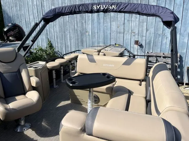 Slide: The Image of 2023 Sylvan L-3 DLZ BAR pontoon boat with beige seating and black accents. - 24