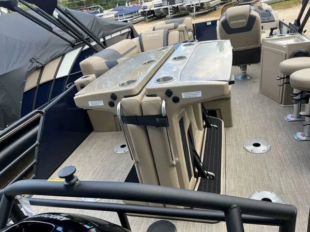 Slide: The Image of 2023 Sylvan L-3 DLZ BAR pontoon boat interior with seating and bar area. - 25