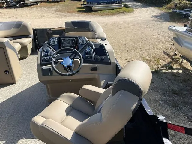 Slide: The Image of 2023 Sylvan L-3 DLZ BAR boat interior with steering console and beige seating. - 26