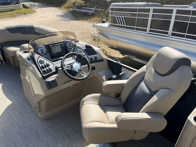 Slide: The Image of 2023 Sylvan L-3 DLZ BAR boat interior with steering console and comfortable seating. - 27