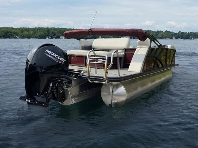 Slide: The Image of 2023 Sylvan X3 CLZ pontoon boat with Mercury engine on a lake. - 1