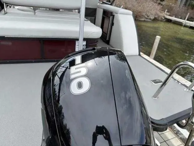 Slide: The Image of 2023 Sylvan X3 CLZ boat with a 150 horsepower engine, docked by the water. - 11