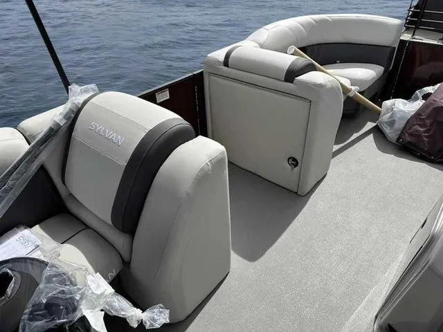 Slide: The Image of 2023 Sylvan X3 CLZ boat interior with plush seating on calm water. - 3