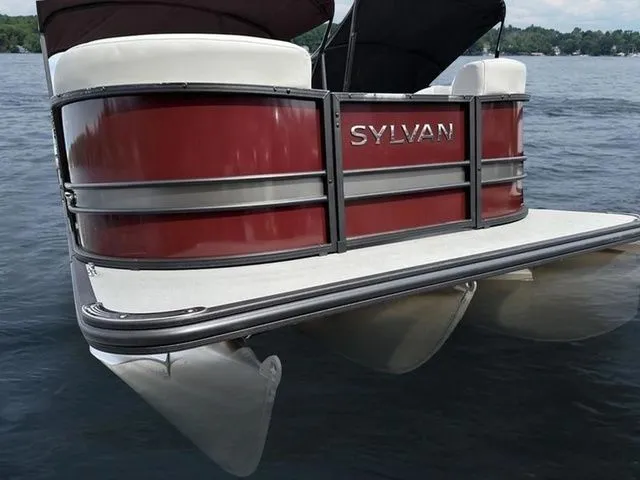 Slide: The Image of 2023 Sylvan X3 CLZ pontoon boat on water, featuring sleek red design. - 6