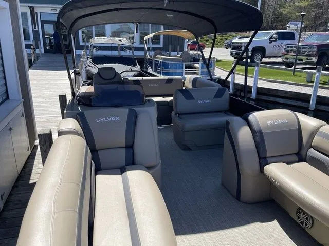 Slide: The Image of 2023 Sylvan L-5 CLZ pontoon boat with spacious seating and canopy at a dock. - 6