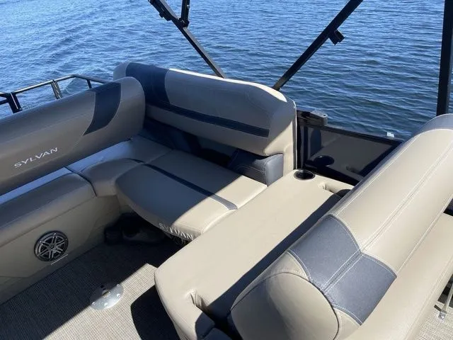 Slide: The Image of 2023 Sylvan L-5 CLZ boat interior with gray seating, cup holder, and water view. - 9