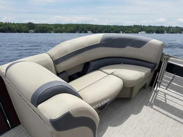 Slide: The Image of 2023 Sylvan L-1 DLZ boat with luxurious seating on a serene lake. - 4