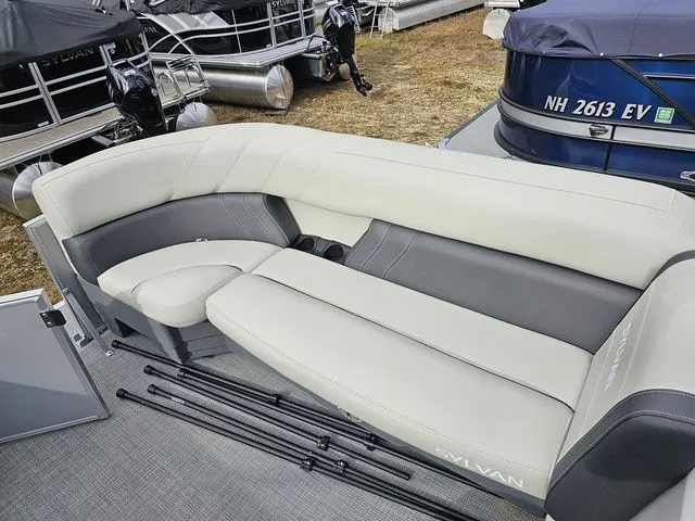 Slide: The Image of 2023 Sylvan 8524 Mirage LZ pontoon boat with beige seating and fishing rods. - 11