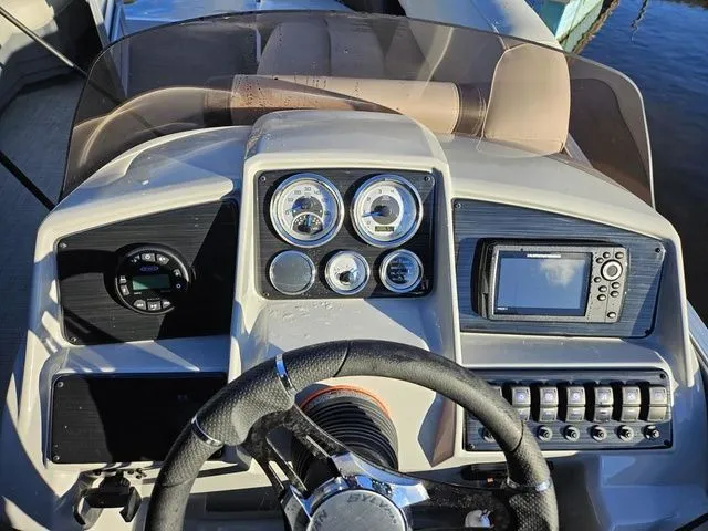 Slide: The Image of 2023 Sylvan 8524 Mirage LZ boat dashboard with gauges and controls. - 5