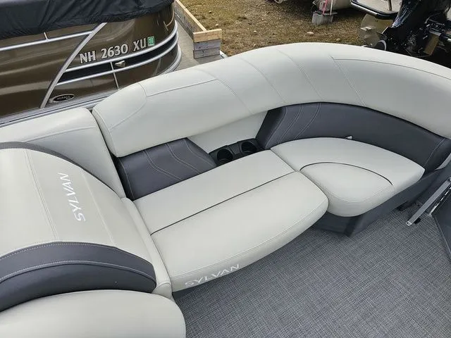 Slide: The Image of 2023 Sylvan 8524 Mirage LZ boat interior with gray cushioned seating. - 7