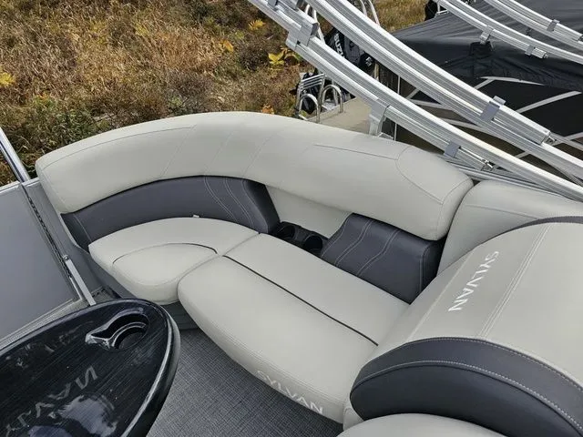 Slide: The Image of 2023 Sylvan 8524 Mirage LZ boat interior with plush seating and sleek design. - 8