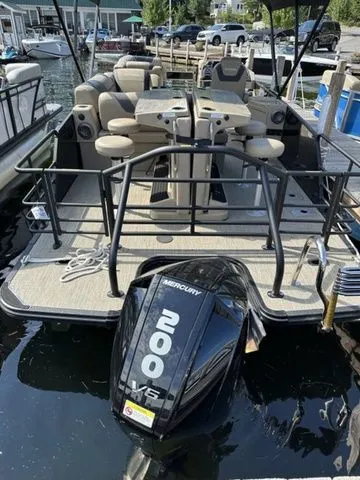 Slide: The Image of 2023 Sylvan L-5 DLZ Bar pontoon boat with Mercury 200 HP engine docked at marina. - 4