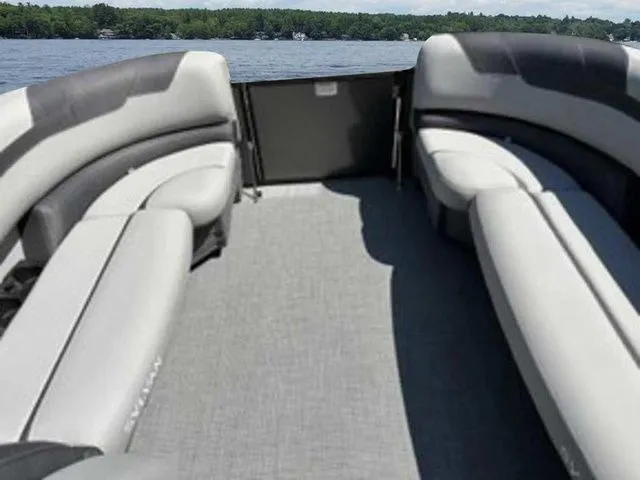 Slide: The Image of 2023 Sylvan L-5 CLZ pontoon boat interior with gray seating and lake view. - 2
