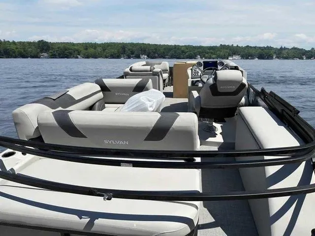 Slide: The Image of 2023 Sylvan L-5 CLZ pontoon boat with spacious seating on a serene lake. - 3