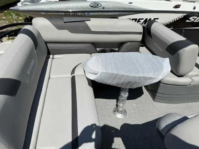 Slide: The Image of 2023 Sylvan L-5 CLZ boat interior with gray seating and covered table. - 5