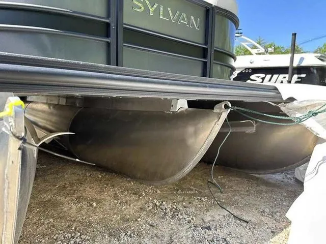 Slide: The Image of 2023 Sylvan L-5 CLZ pontoon boat with visible undercarriage and pontoons. - 6