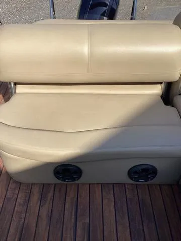 Slide: The Image of 2018 Harris 230 Sunliner Sport boat seat with beige upholstery and wooden deck. - 10