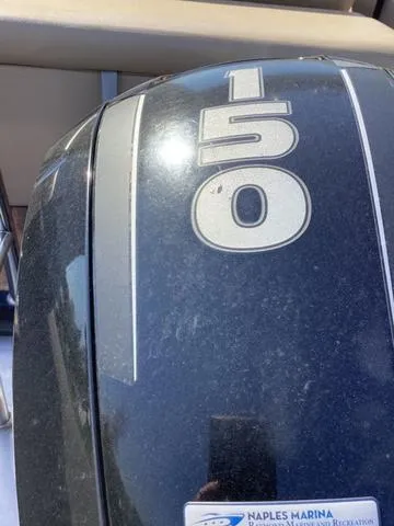 Slide: The Image of Close-up of a 150 HP outboard motor on a 2018 Harris 230 Sunliner Sport. - 17