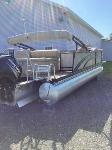 Slide: The Image of 2018 Harris 230 Sunliner Sport pontoon boat with Mercury engine, parked outdoors. - 3