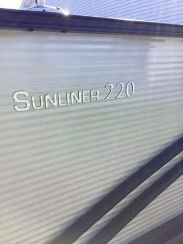 Slide: The Image of 2018 Harris 230 Sunliner Sport boat with "Sunliner 220" branding on the side. - 4