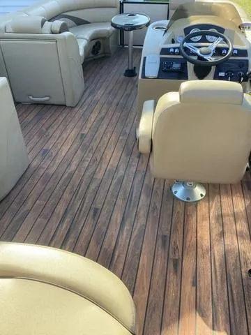 Slide: The Image of 2018 Harris 230 Sunliner Sport interior with beige seating and wood-style flooring. - 8