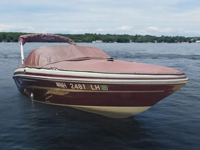 Slide: The Image of 2013 Tahoe Q5i boat with cover on a lake, surrounded by trees. - 4